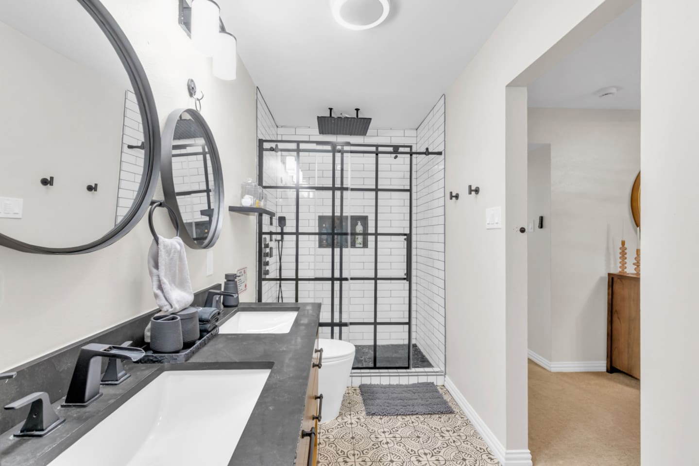 Spacious shower with dual heads and a rainfall option designed to fit two people comfortably in spa like style