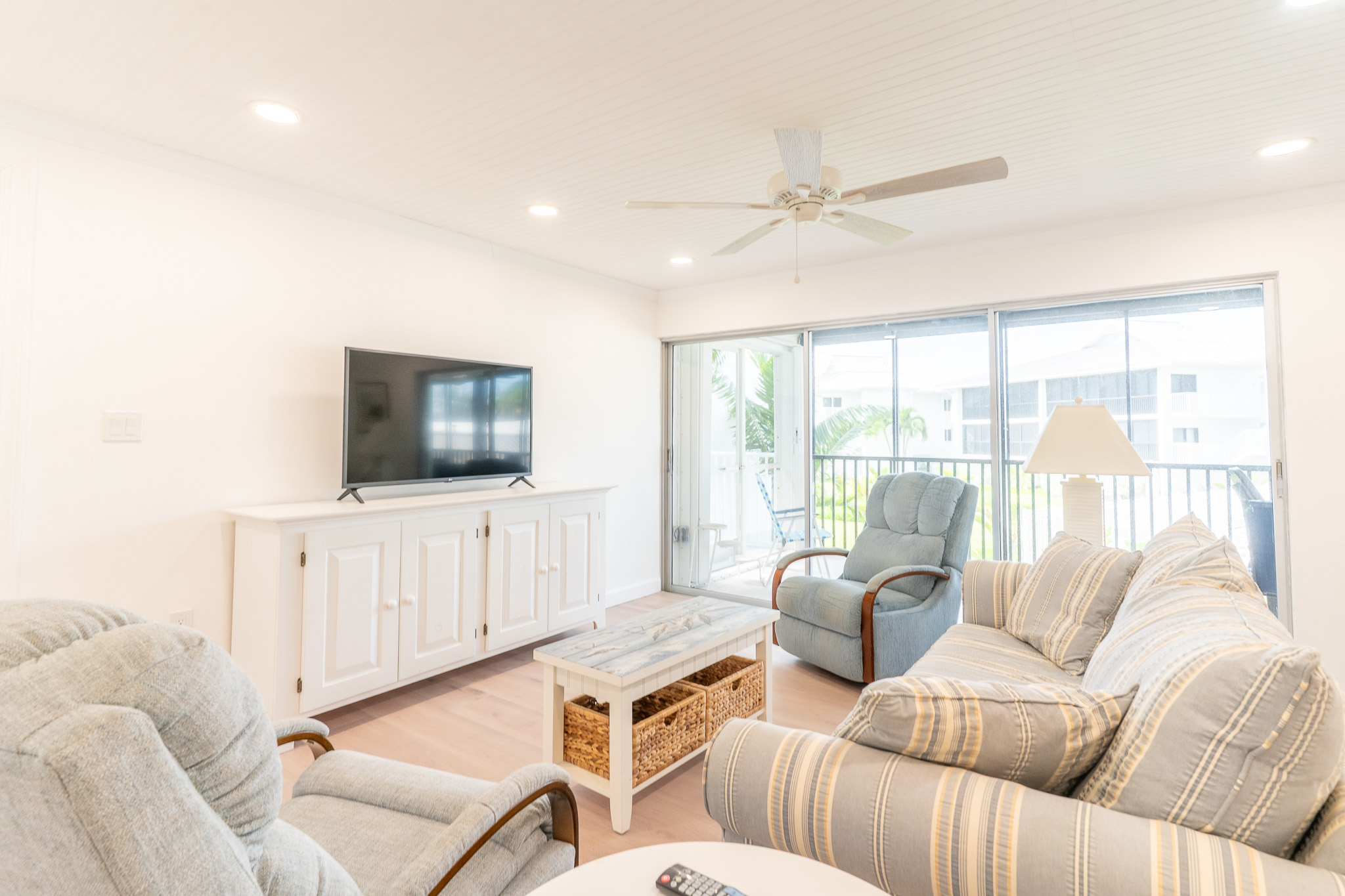 Living area is open to the kitchen and has 2 swivel  rockers and comfortable couch.