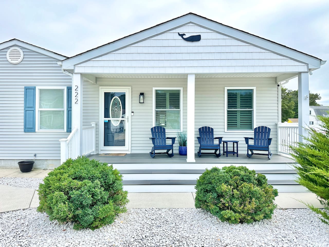 Welcome to your coastal escape, featuring a charming covered front porch with comfortable Adirondack rockers. This inviting entrance is the perfect spot to enjoy your morning coffee or feel the ocean breeze while taking in the quiet neighborhood views.