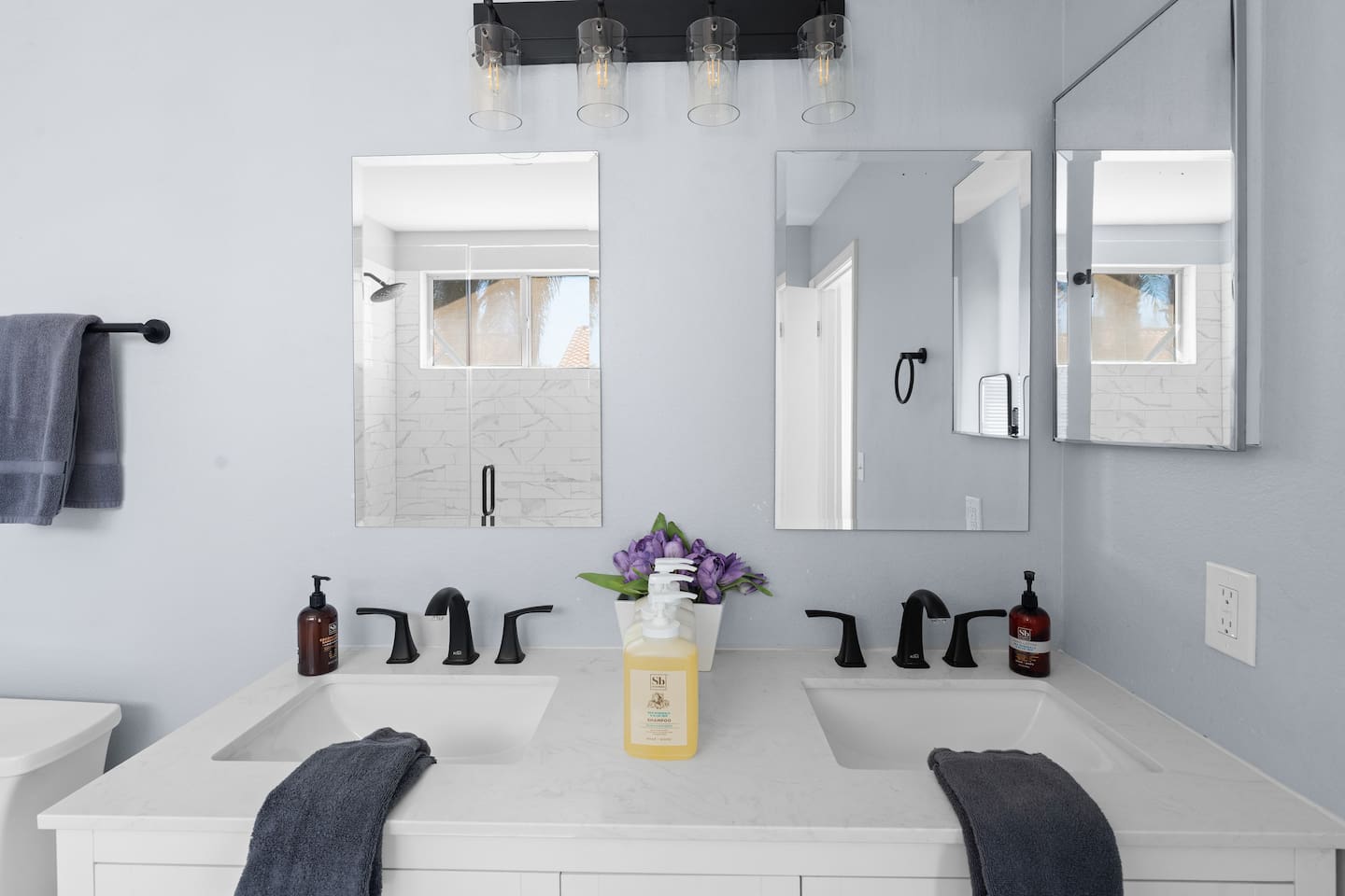 The primary bathroom has two sinks and nice, remodeled finishings.