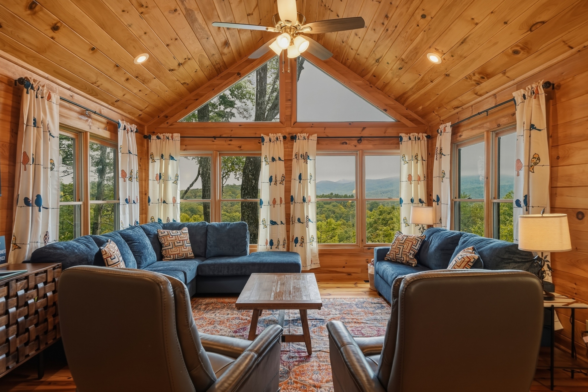 Living area with lots of seating, fire place and smart TV