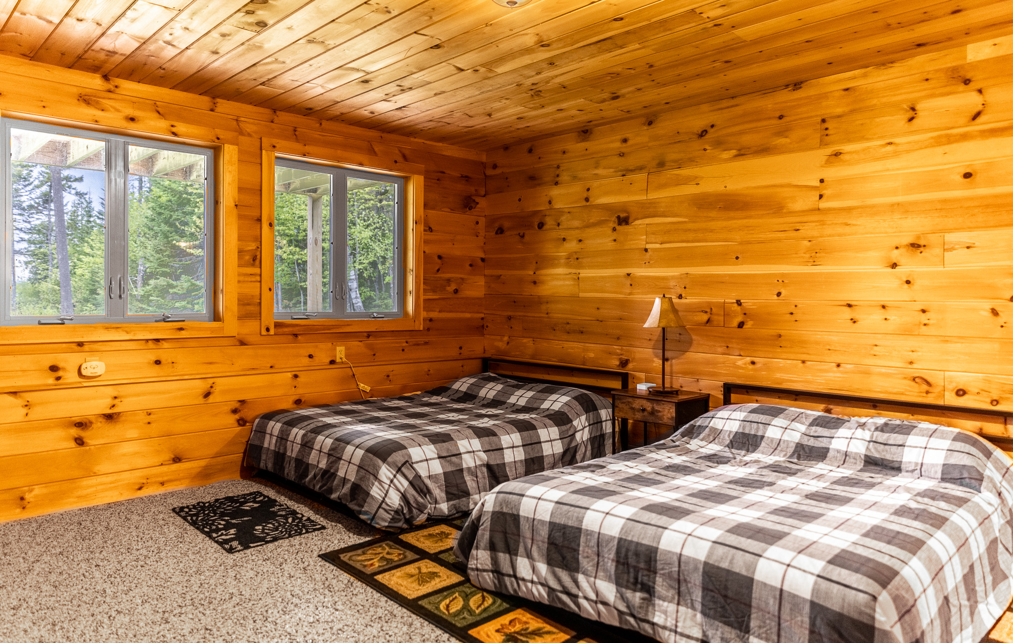 Enjoy the downs floor suite with views of the beautiful lake, a full attached bathroom, TV for streaming, clothing storage, and charger stations by 2 queen beds.