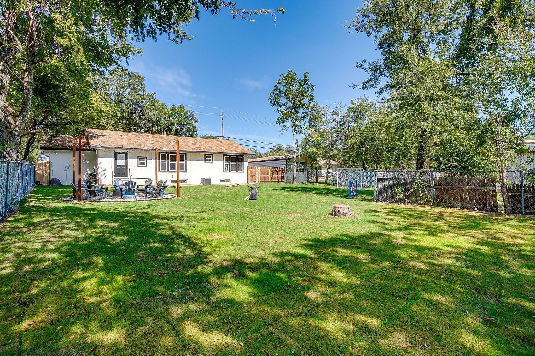 Perfect for gatherings—shaded trees and play space in a quiet, fenced backyard