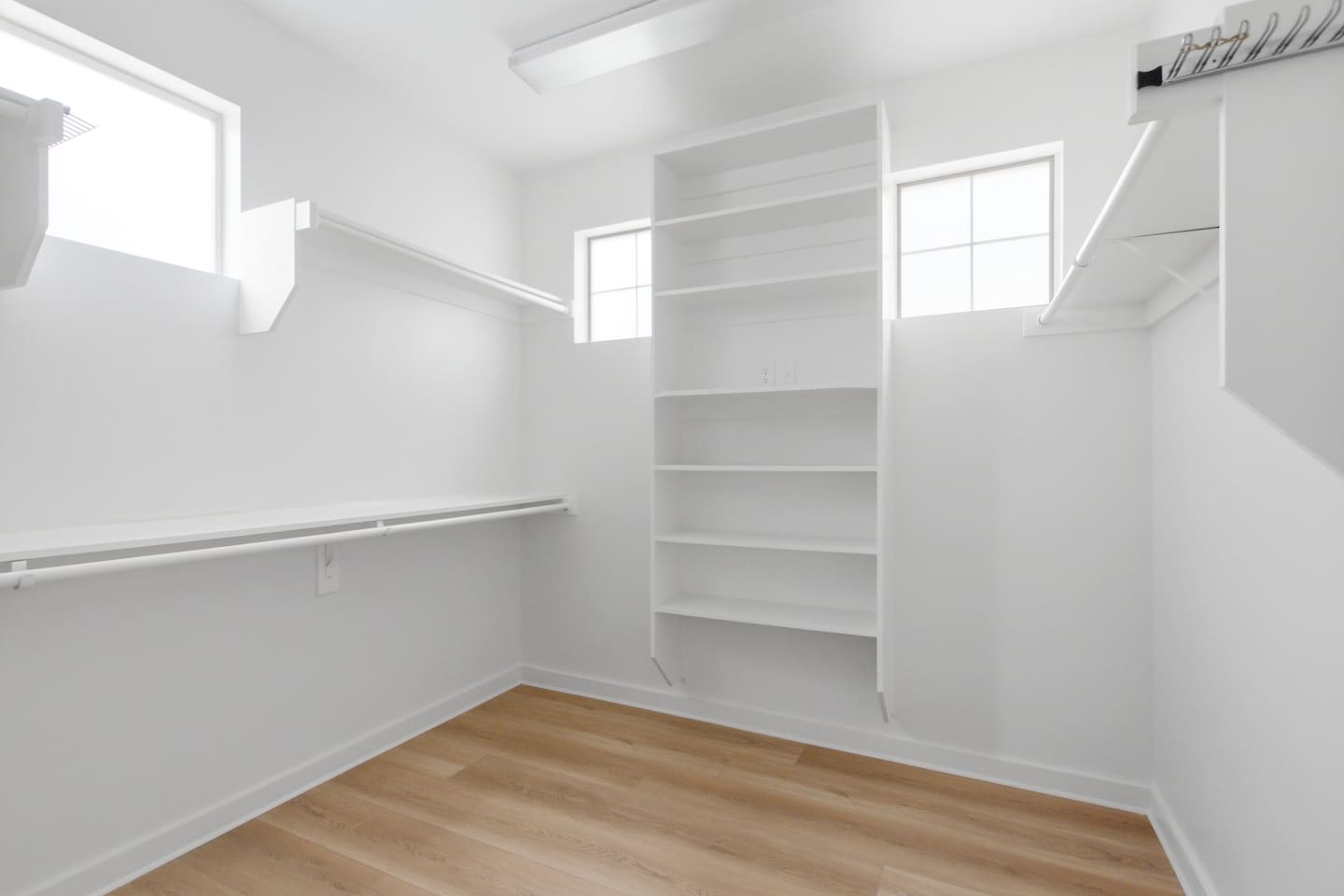 Primary suite walk-in closet with generous built-in shelving on every wall. Plenty of room to fully unpack and settle in, whether you are here for a long weekend or a full week.

