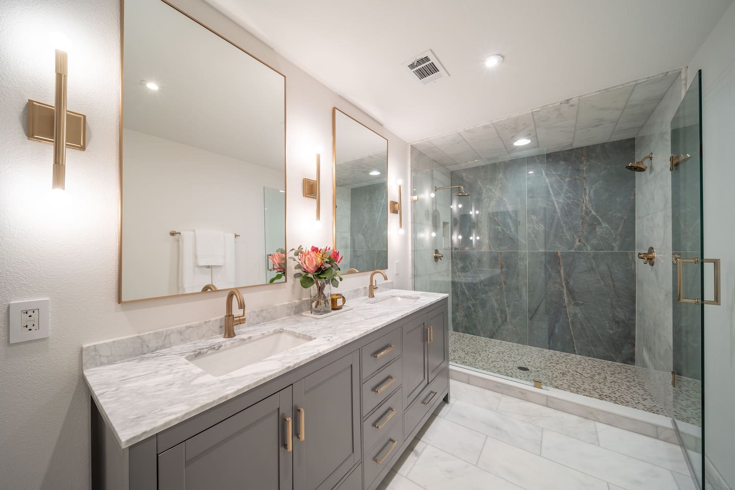 Spa-style primary ensuite with dual vanities, marble finishes, and walk-in shower. Shampoo, conditioner, body wash, and hand soap are available for you to use during your stay. 