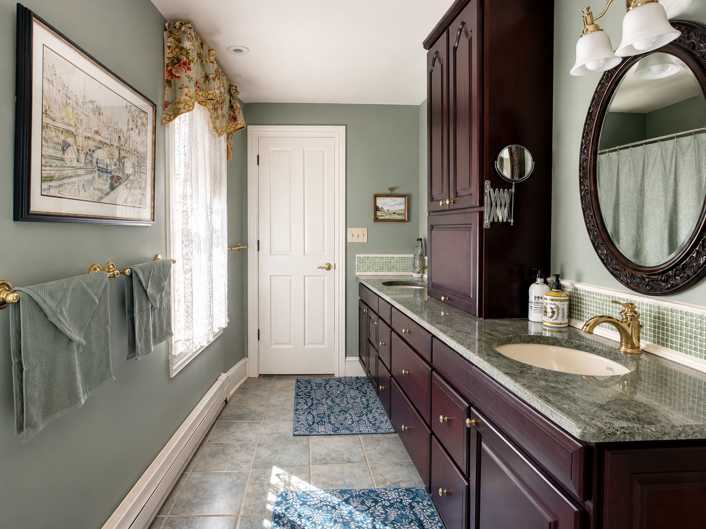 The primary en suite — double mahogany vanity, granite counters, brass fixtures, and a green glass tile backsplash. A proper bathroom for a proper Cape May summer.
