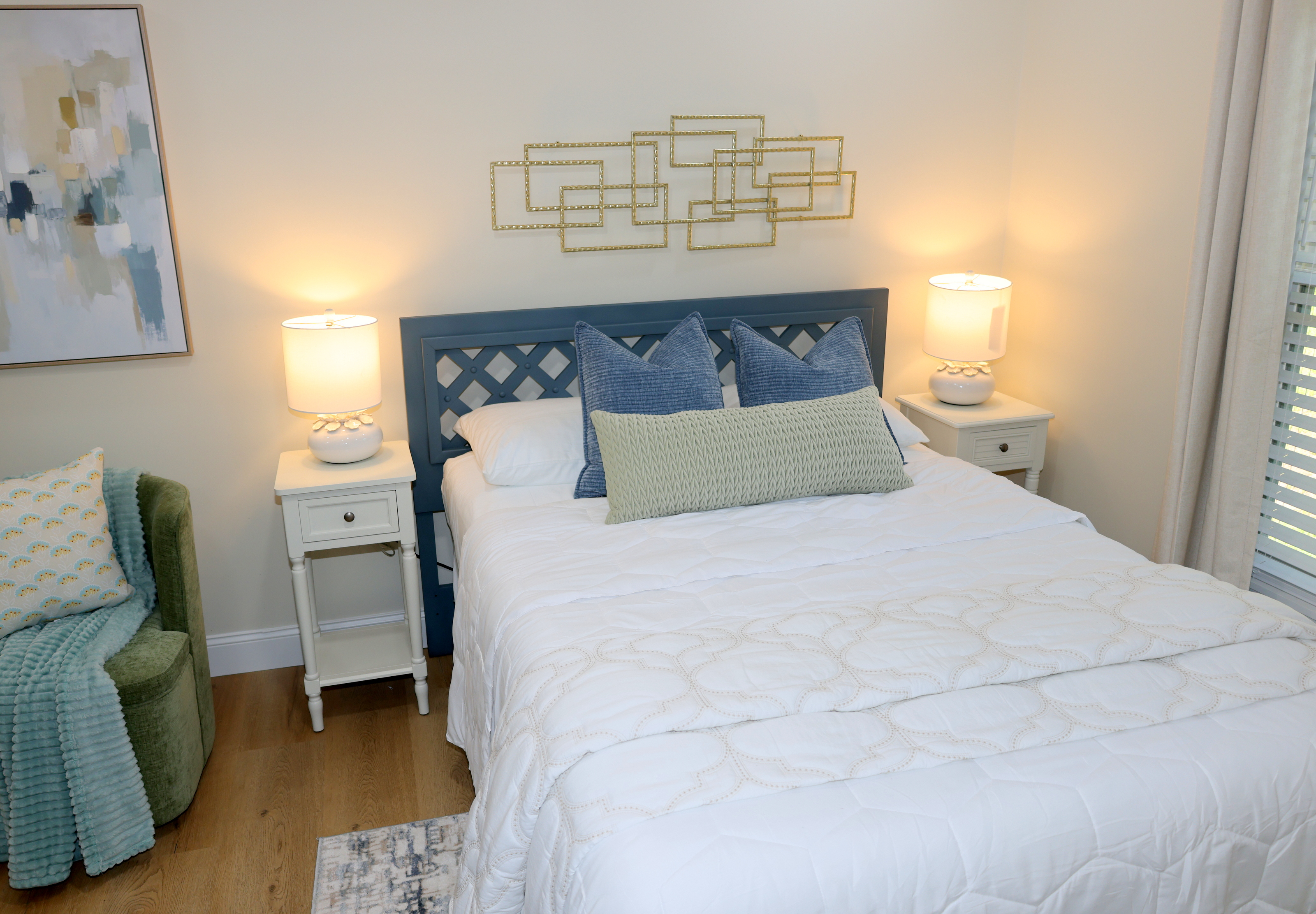 Comfortable bedroom with soft bedding, bedside lighting, and relaxing lake-house style