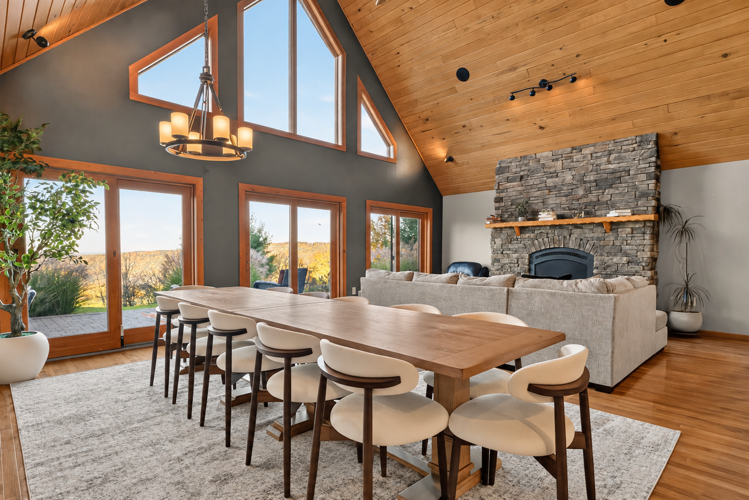 Dining area with vaulted ceiling and stone fireplace
