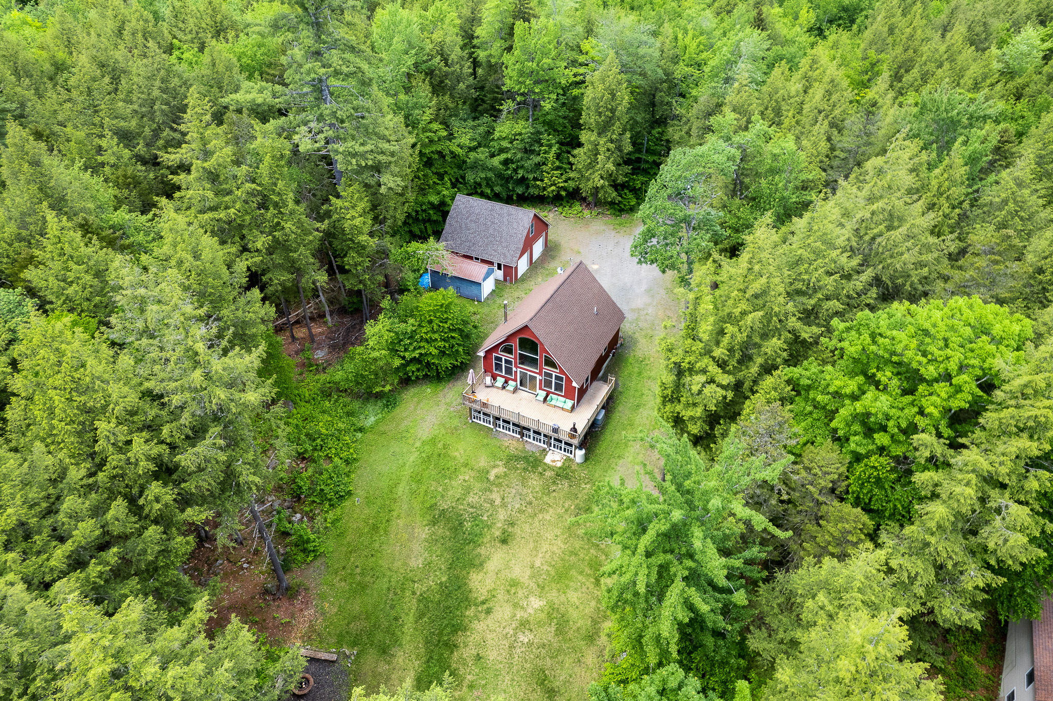 Aerial view of the house and the backyard with outside fire pit area. Peaceful and quiet surroundings that are perfect to unplug and relax.