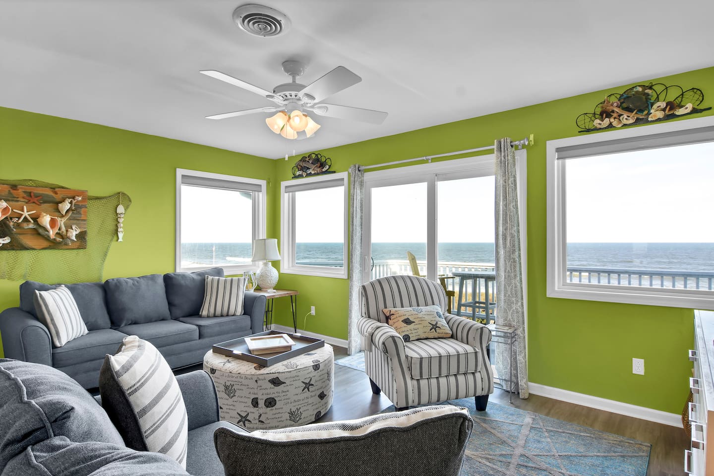 Living room leads to balcony with sweeping views of the beach and ocean!