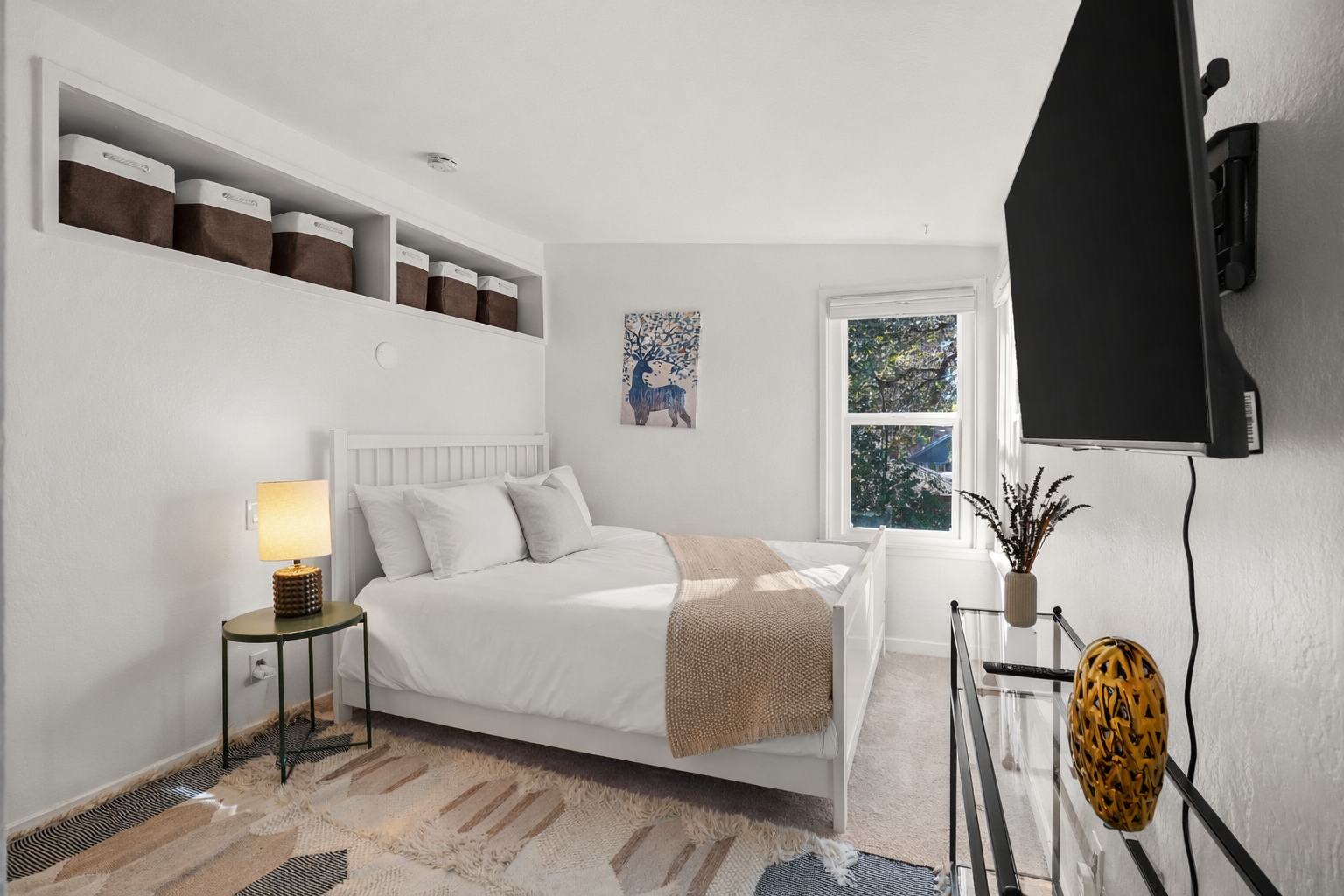 This inviting bedroom features a comfortable queen bed, Smart TV, and a spacious armoire for clothing and storage. It's a cozy, well-appointed space designed for a relaxing and comfortable stay.