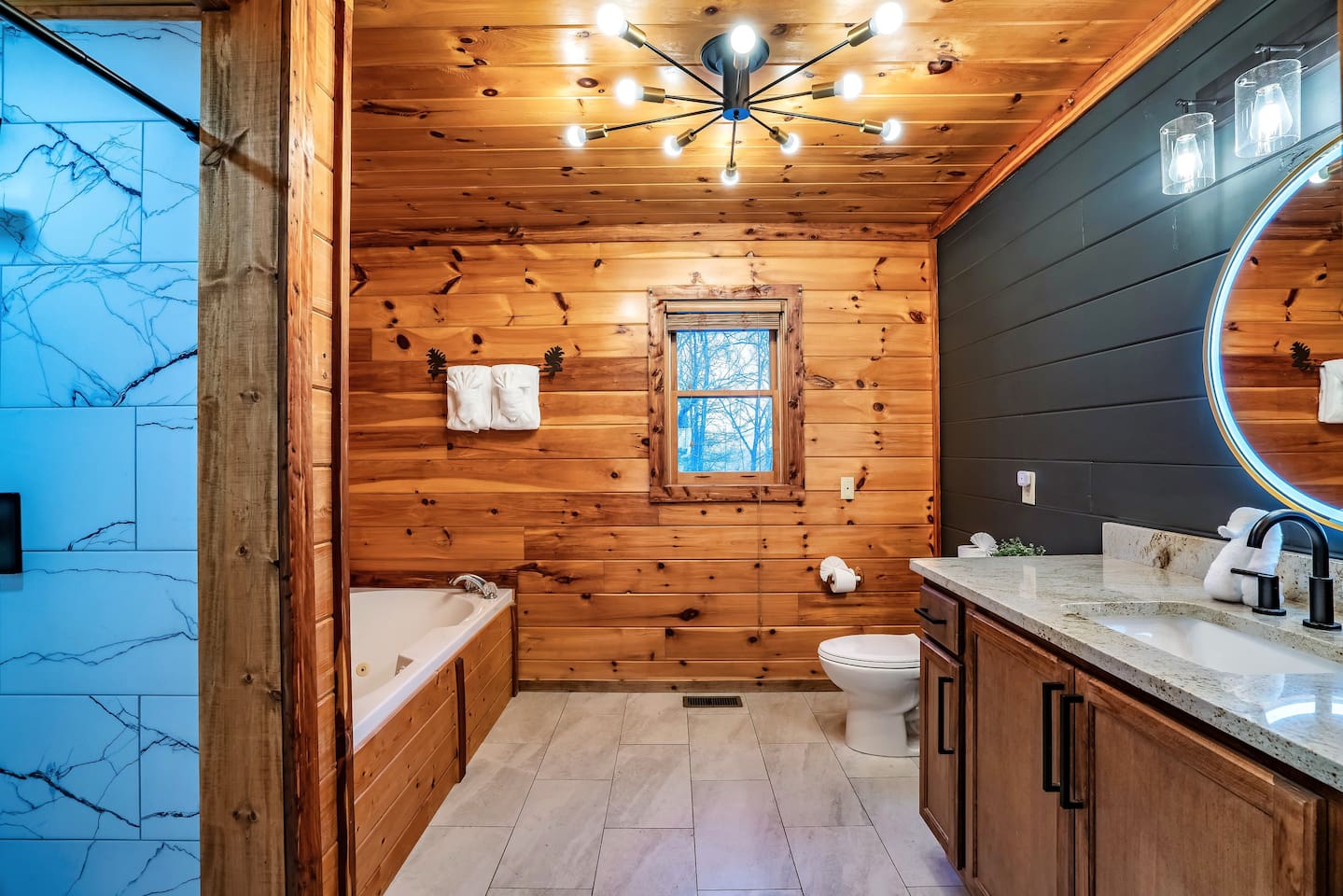 Stylish mountain cabin master bathroom with bold darkened accent wall, modern finishes, and a serene, cozy retreat vibe.