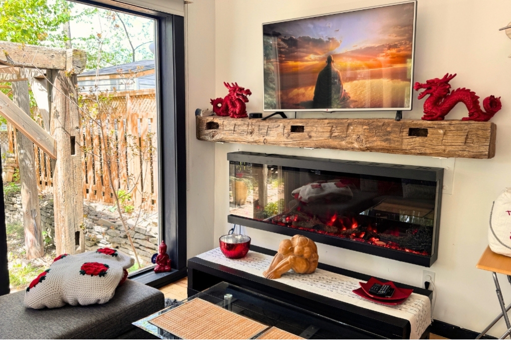 Watching TV by the cozy fireplace inside the Peterborough ZEN Retreat.
