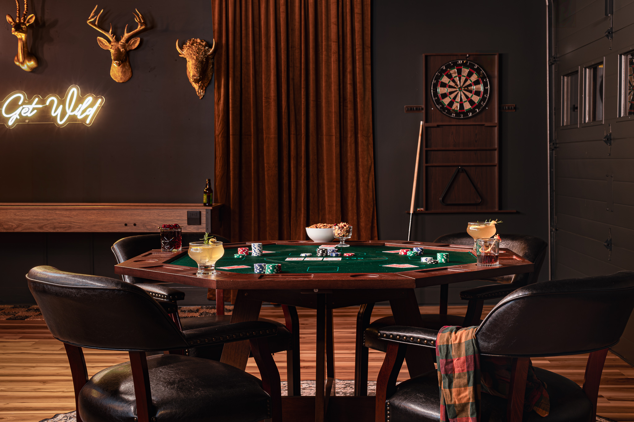 {Speakeasy Game Room} Deal a hand at the poker table, challenge someone to darts, and let the evening unfold without ever leaving the house.