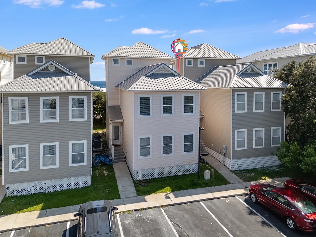 Our three-story townhouse sits directly on 30A and is right across the street from public beach access.  It has two dedicated parking spaces and may provide additional parking as available.