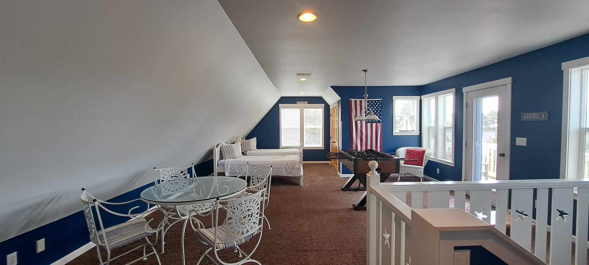 Fun-filled top-floor loft with twin beds, an air hockey and game table, plus a peek of the ocean from the deck and a refreshing coastal breeze.