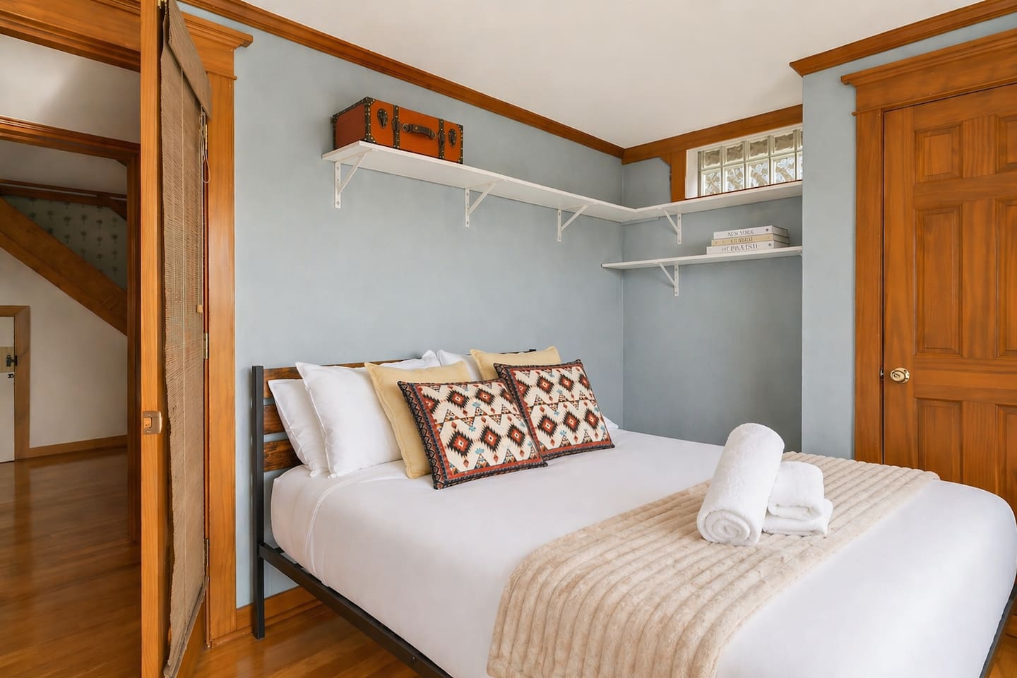 “Enjoy this bright downstairs bedroom featuring a glass door with direct access to the balcony, hot tub, and spa. Relax in comfort with soft bedding and natural light, while vintage suitcase décor adds a charming touch of travel-inspired style.”