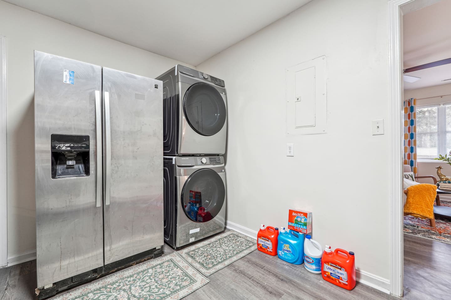 A convenient laundry area featuring a washer, dryer, and laundry essentials like detergent and fabric softener — perfect for guests who need to do laundry during their stay.
