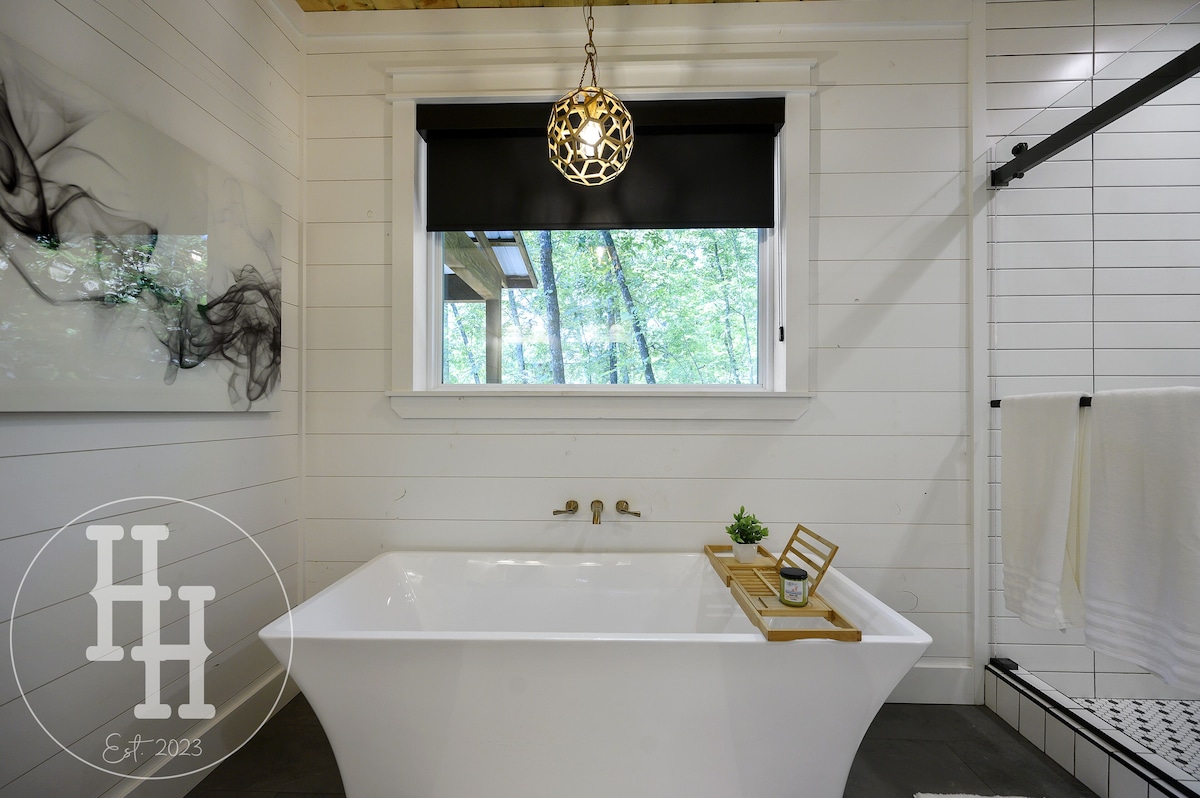 Window over the tub for natural light to view the trees or privacy shade.