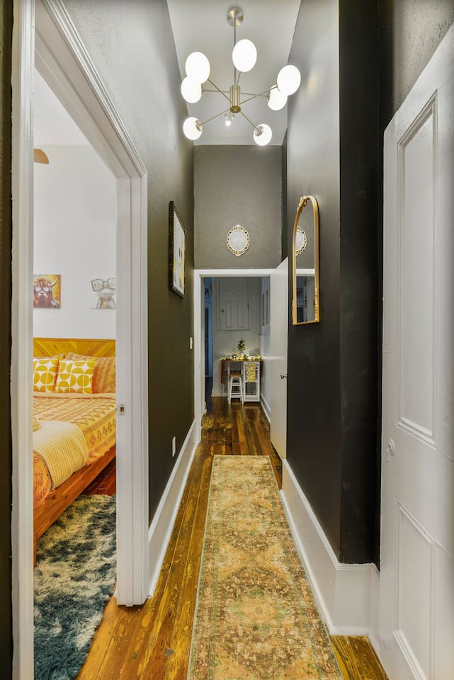 The contrast of rugged original wood floors and modern lighting and design creates a time-traveling vibe, blending the past with the present.