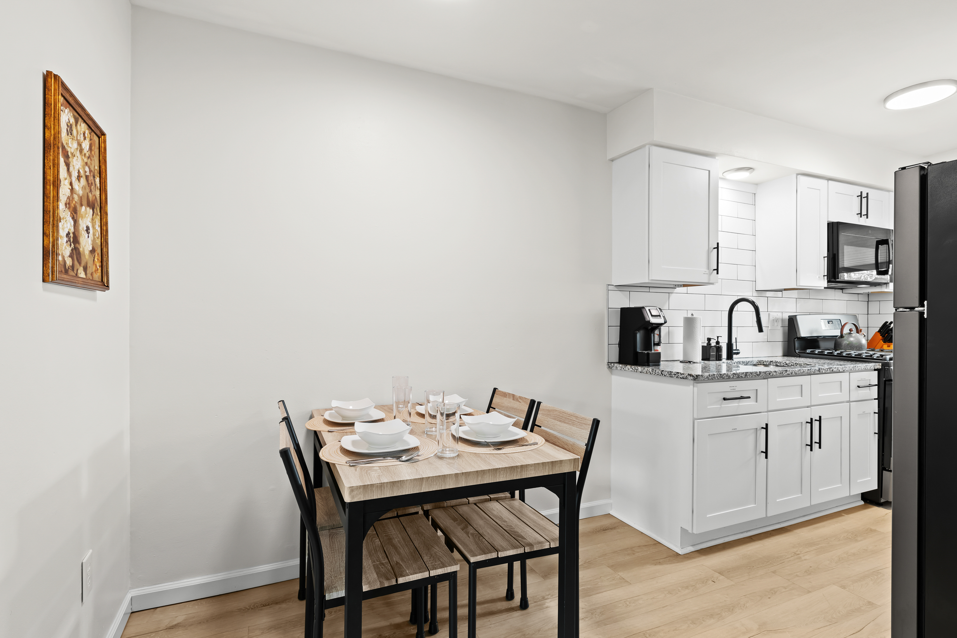 Enjoy meals and morning coffee in this cozy dining nook and modern kitchen—fully equipped for your stay.