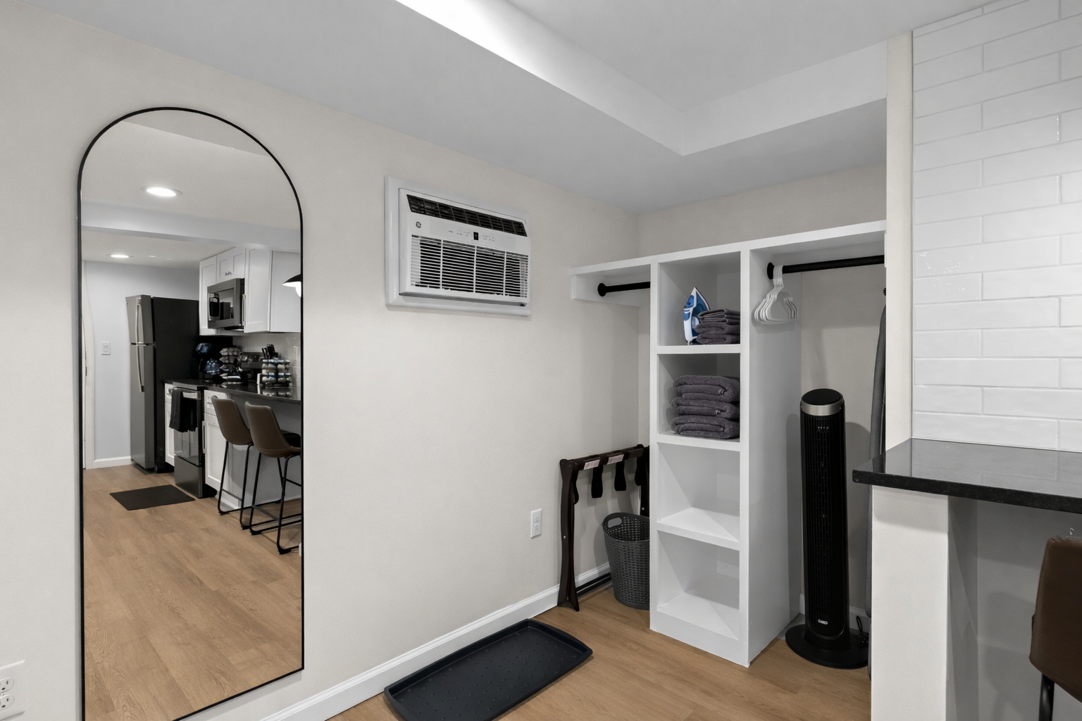 Smart storage and prep area with open shelving, hanging space, and a full-length mirror—perfect for staying organized and settling in with ease.