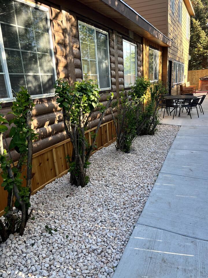 Restful, serene backyard area includes the hottub, additional eating areas and relaxing  patio swings and chairs for visiting together.