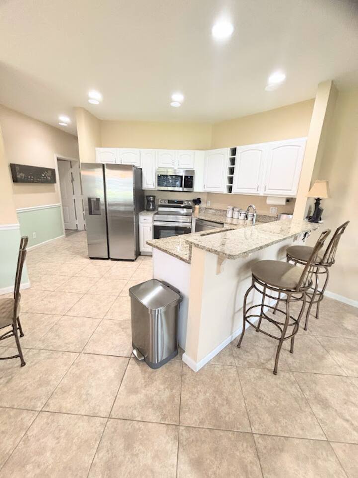 Updated kitchen with stainless steel appliances, granite countertops, breakfast bar seating, and plenty of cabinet space.
