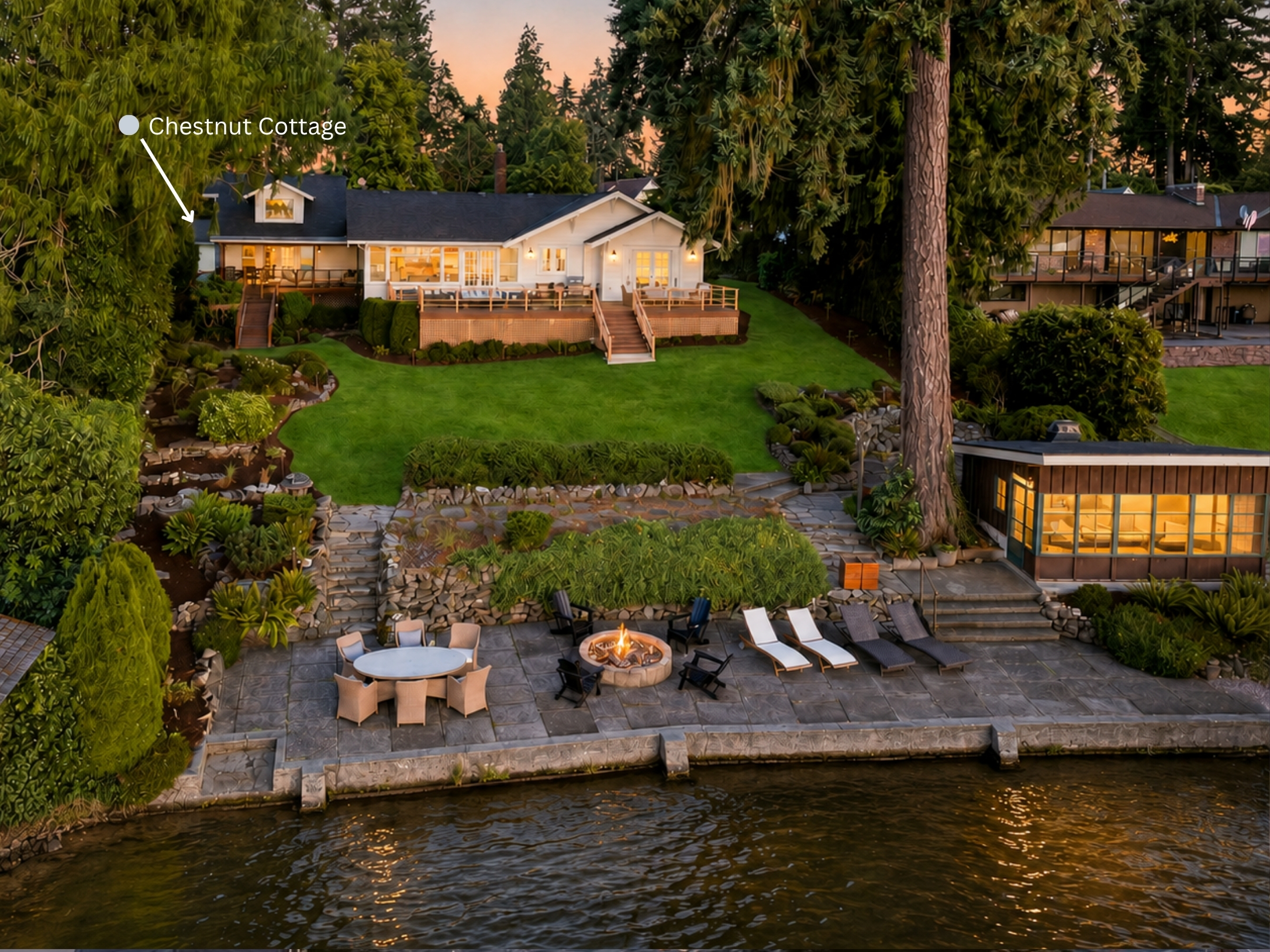 Viewed from the lake, Chestnut Cottage is on the left side of the main residence, with its private deck clearly visible. Haven unfolds across nearly an acre, with shared lawns, a glowing firepit, waterfront structures and 100 feet of shoreline.