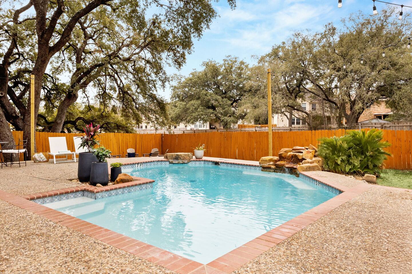 The spacious backyard with the large pool and hot tub will make you want to stay forever.
