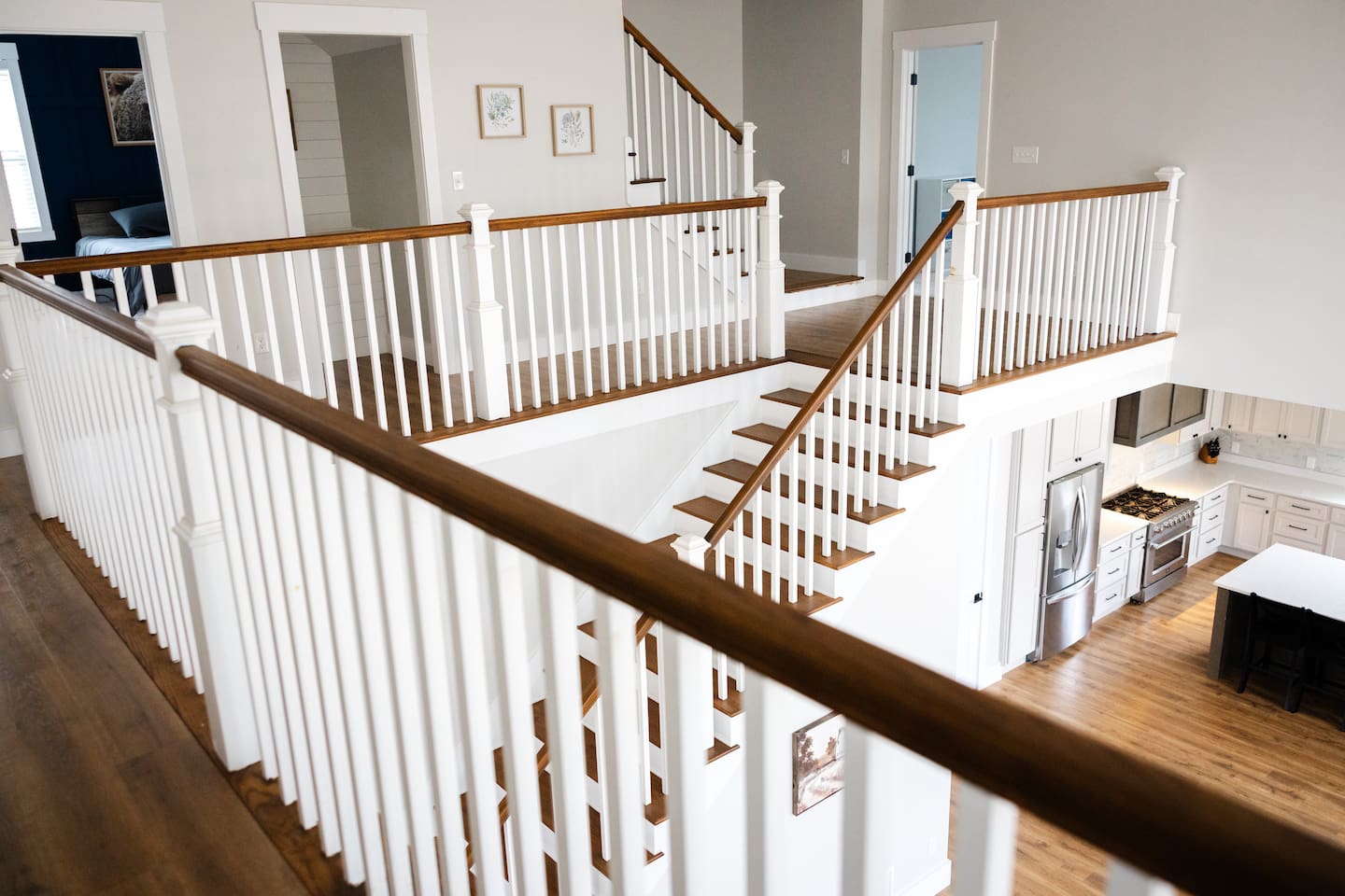 View from doorway of bedroom #5 looking down to kitchen/living room area. 