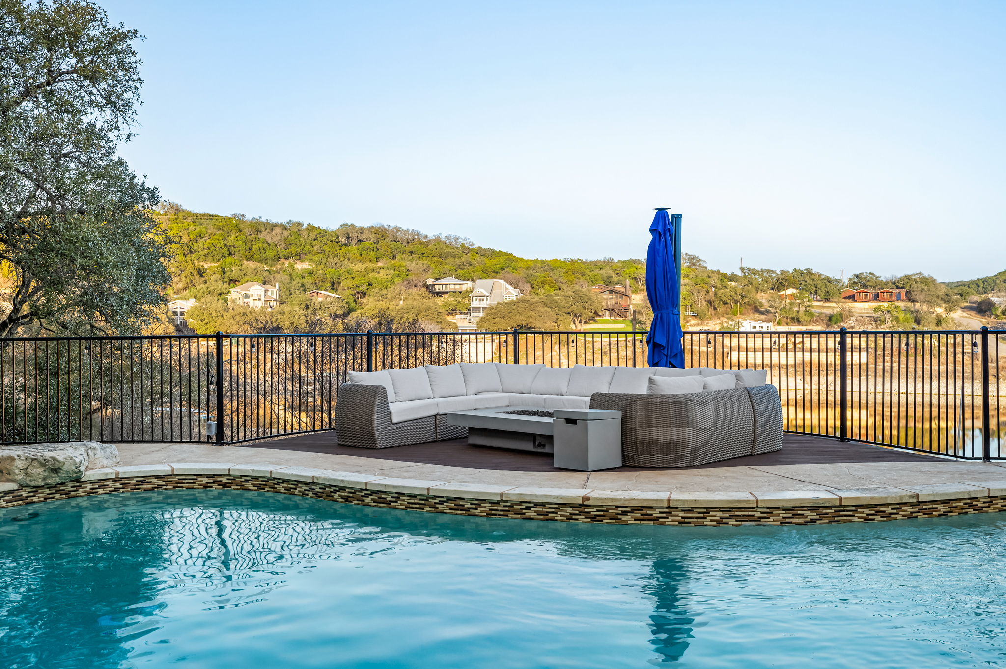 Poolside sun deck with plush seating overlooking the water.