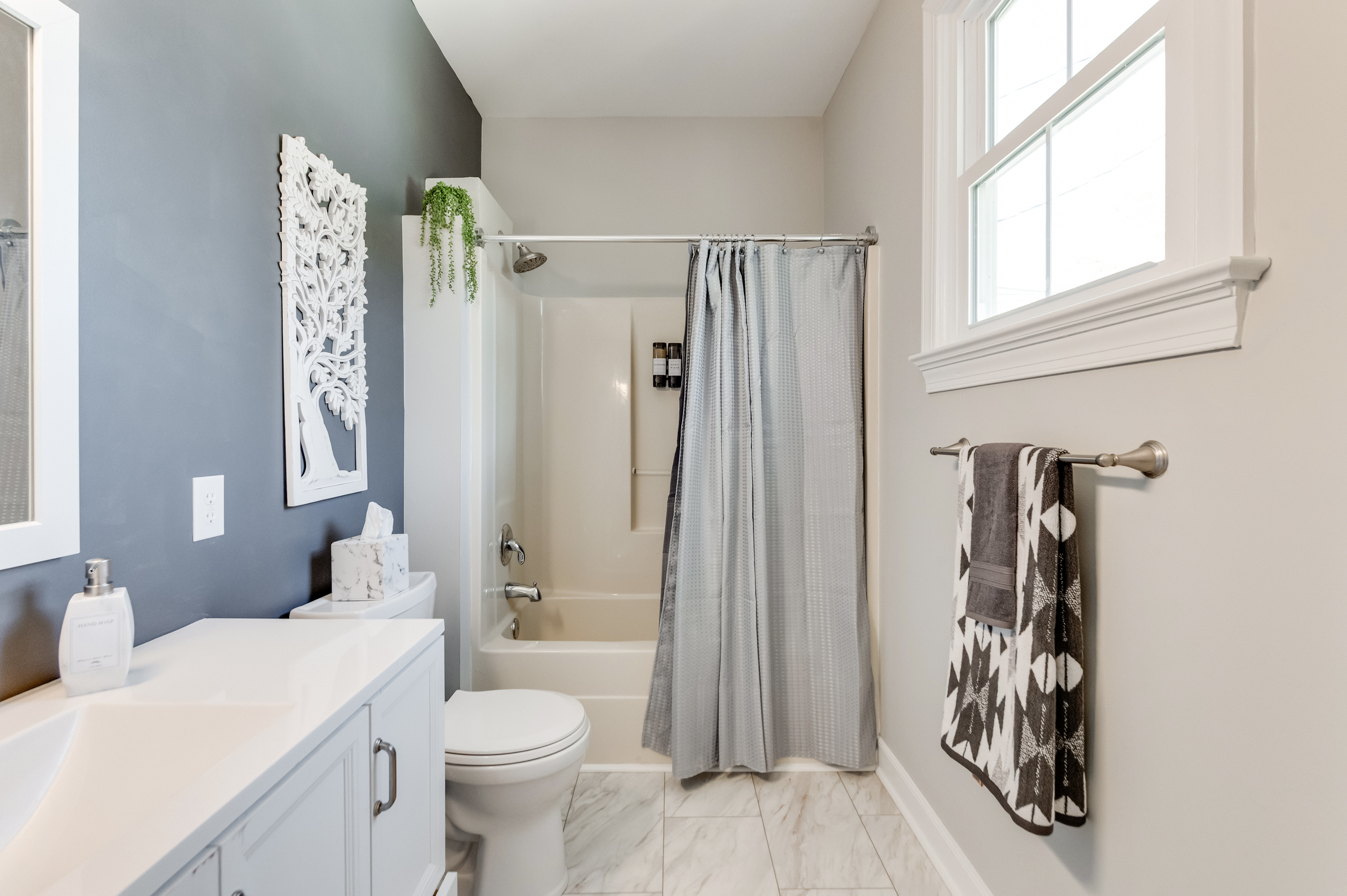 Bathroom 1 (Hallway): Fresh decor, elegant fixtures, and natural light create your perfect spa getaway!