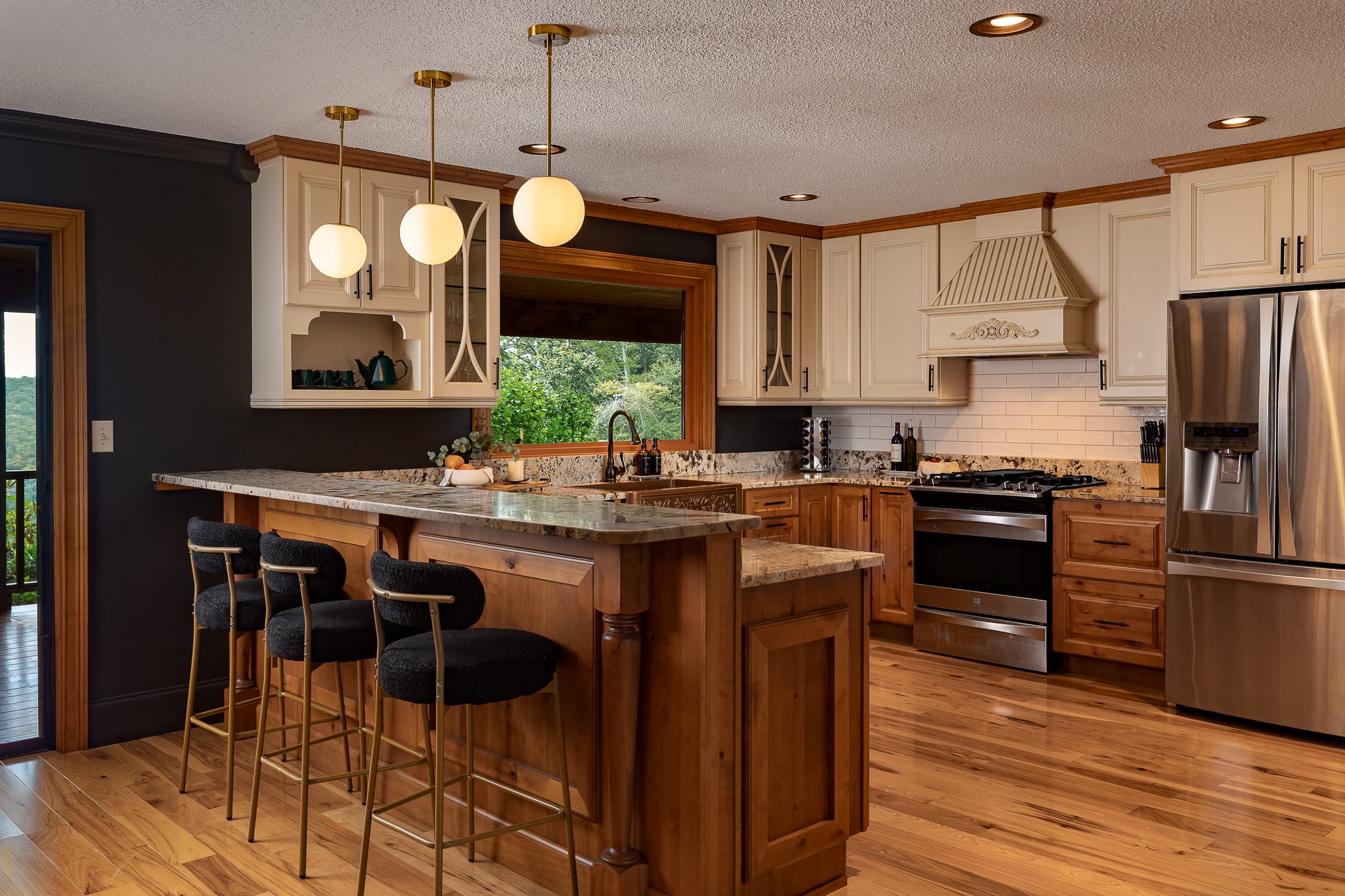 {Kitchen} Cook, gather, and stay connected in the open kitchen with a large island, bar seating, and plenty of prep space for group meals.