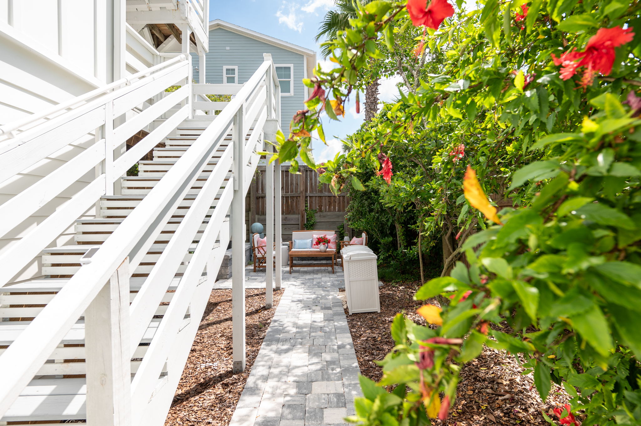 Descend the side stairs and step into your own tropical oasis! The backyard is a cozy retreat, lined with stunning Floridian vegetation and featuring a lush lime tree—perfect for relaxing and enjoying the serene surroundings.