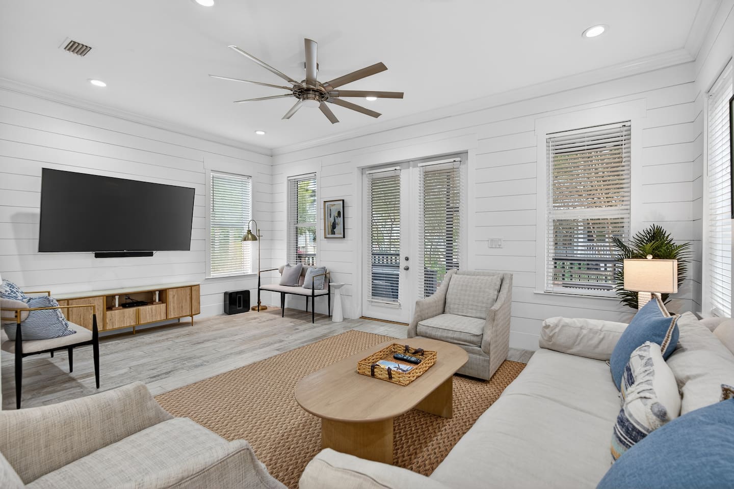 Spacious living room with smart TV, Sonos speakers and subwoofer, plenty of seating for everyone, and access to the screened-in porch and backyard. 