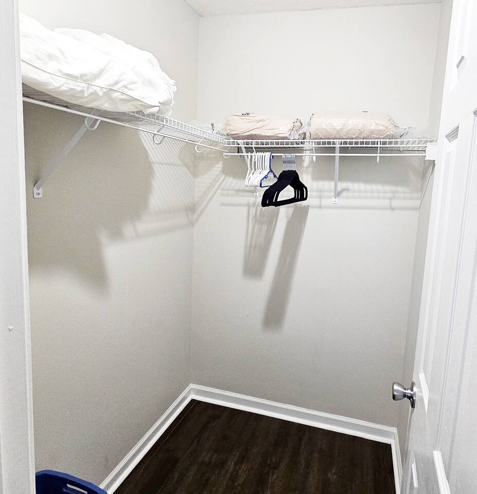 A nice-sized walk-in closet is attached to this room. There are extra hangers, linen, pillows, and blankets found here.