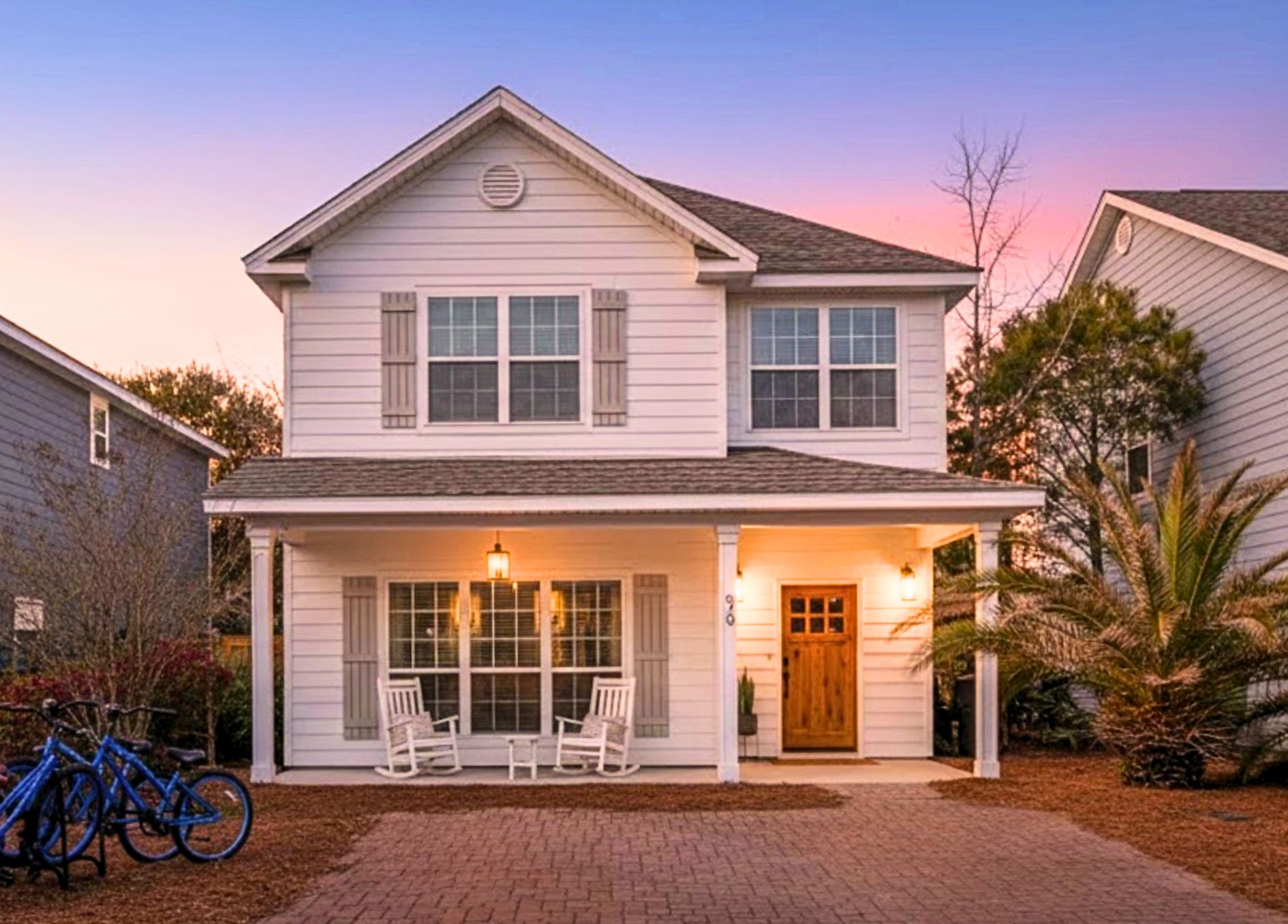 Front Exterior: Welcome to your newly painted coastal retreat, featuring secure on-site parking for two full-sized vehicles.