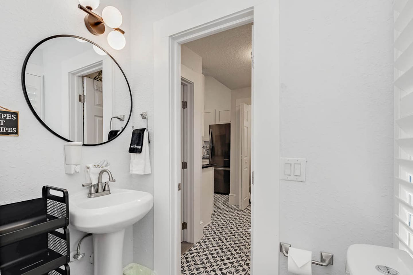 bathroom in back corner of house near kids room and back door with tub shower combination