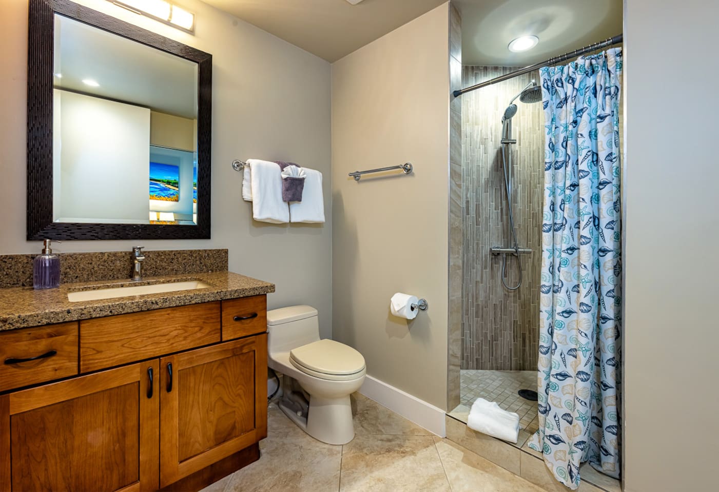 the main bathroom features a vanity and large walk-in shower with rain shower-head