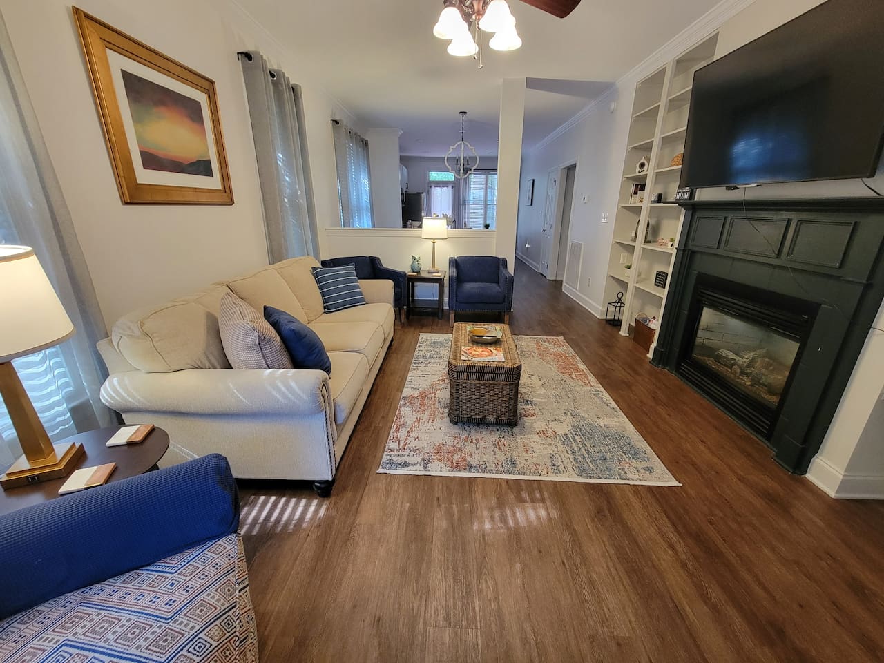 Well appointed living with comfortable study furniture, gas fireplace, and large TV.   Open to dining area and kitchen.