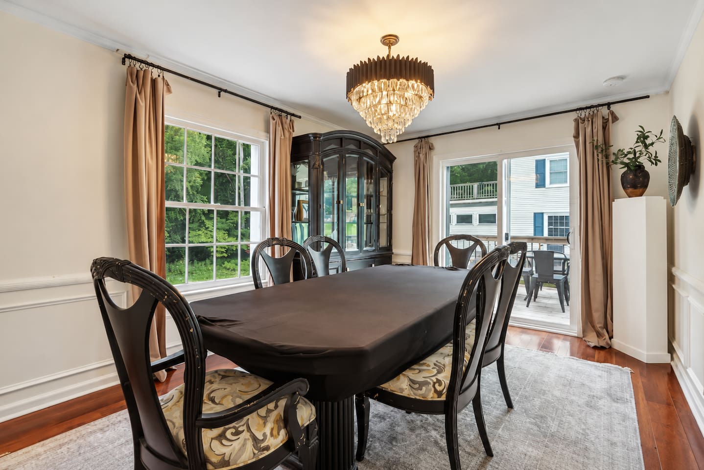 Gather around the dining table for shared meals and easy conversation, with bright windows and elegant lighting creating a welcoming setting.