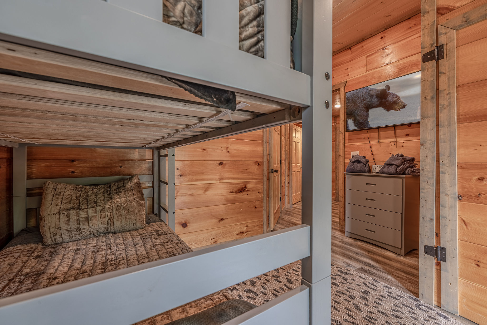 A second look at Junior Explorers’ Quarters, featuring cozy cabin details, a Smart TV, and playful explorer-inspired style.