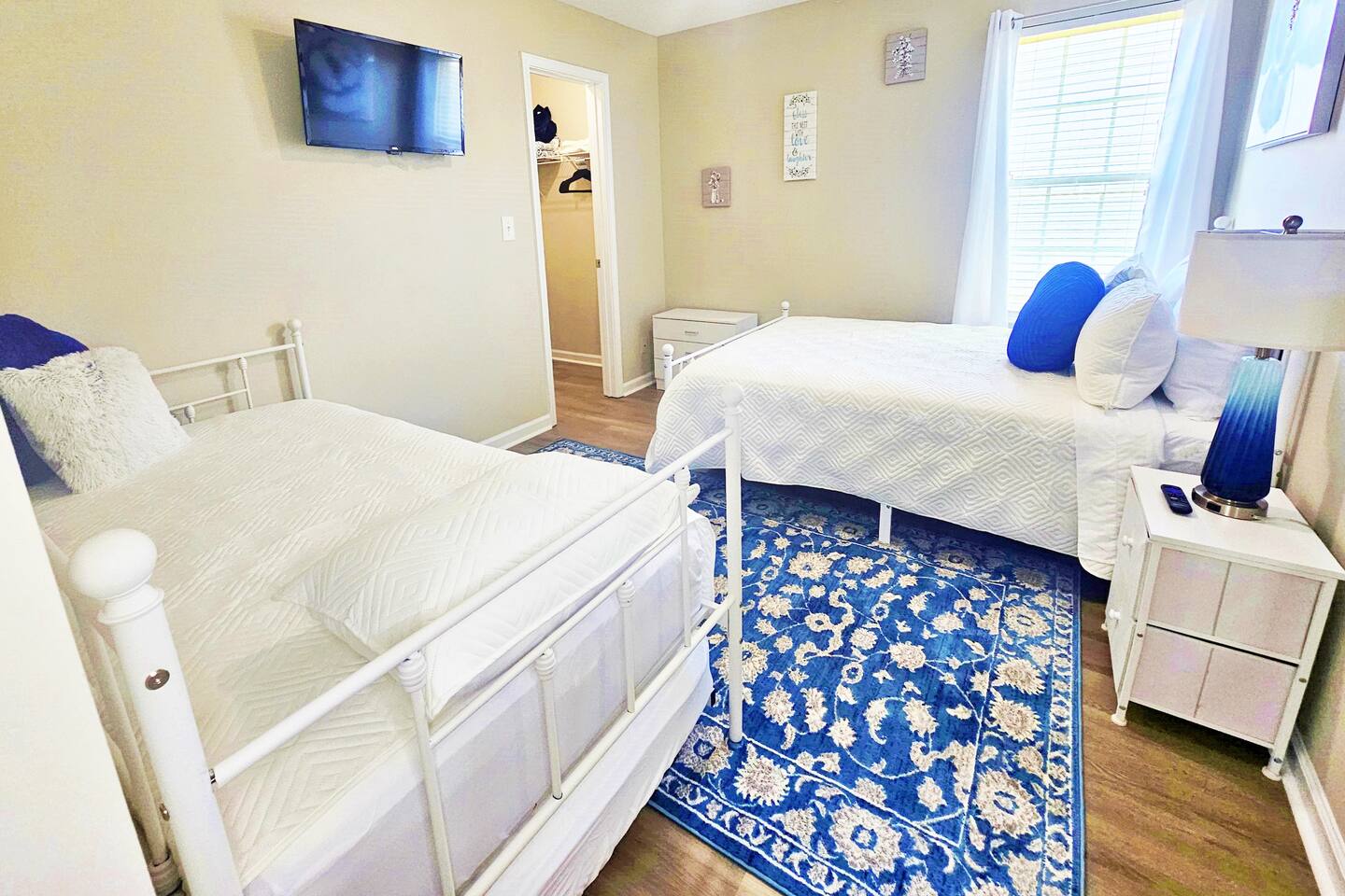 This serene bedroom can sleep up to 4 adults. Full-length mirror and flat screen smart TV in here as well!