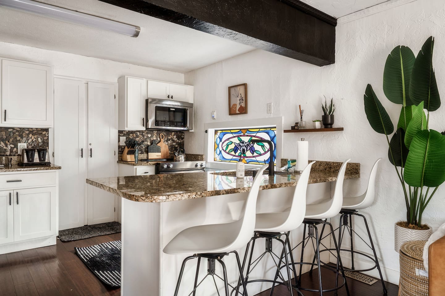 Unique kitchen with modern appliances and stained glass