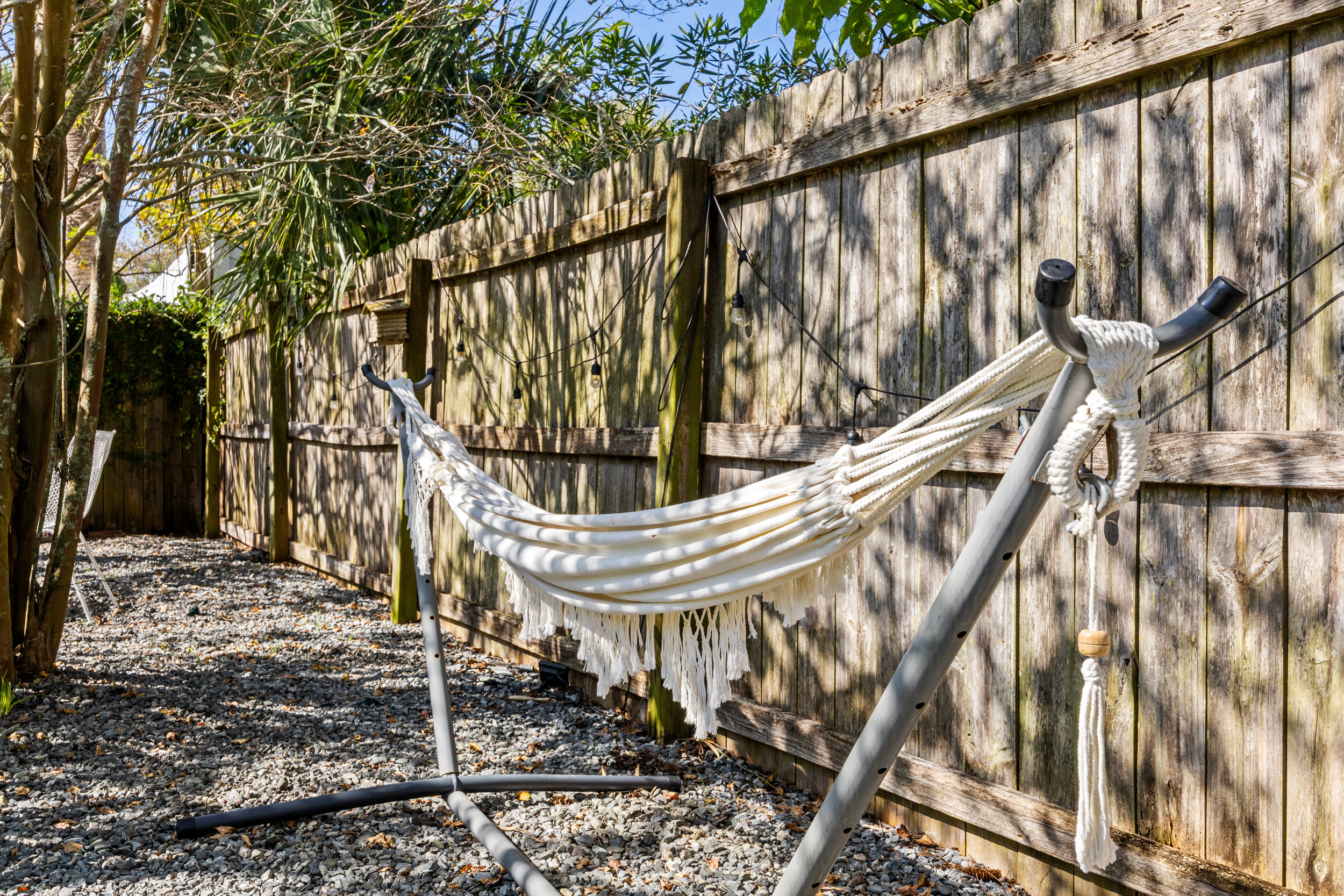 Relaxing Rope Hammock
A classic white rope hammock on a sturdy stand, surrounded by trees and soft lighting. A serene escape ideal for an afternoon nap or quiet downtime.