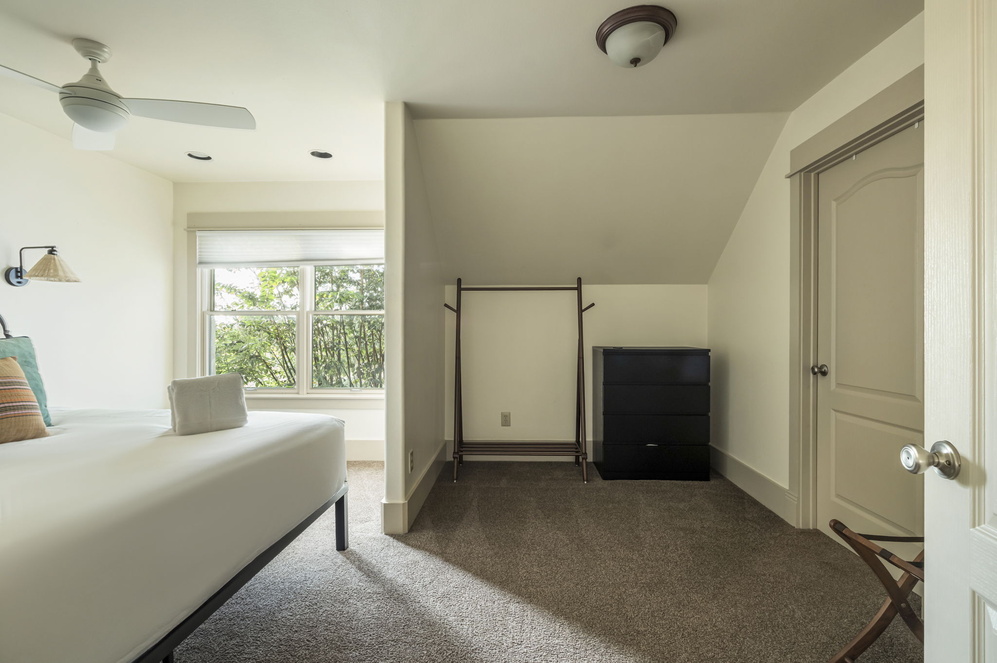 A dedicated dressing area with a clothes rack and dresser.