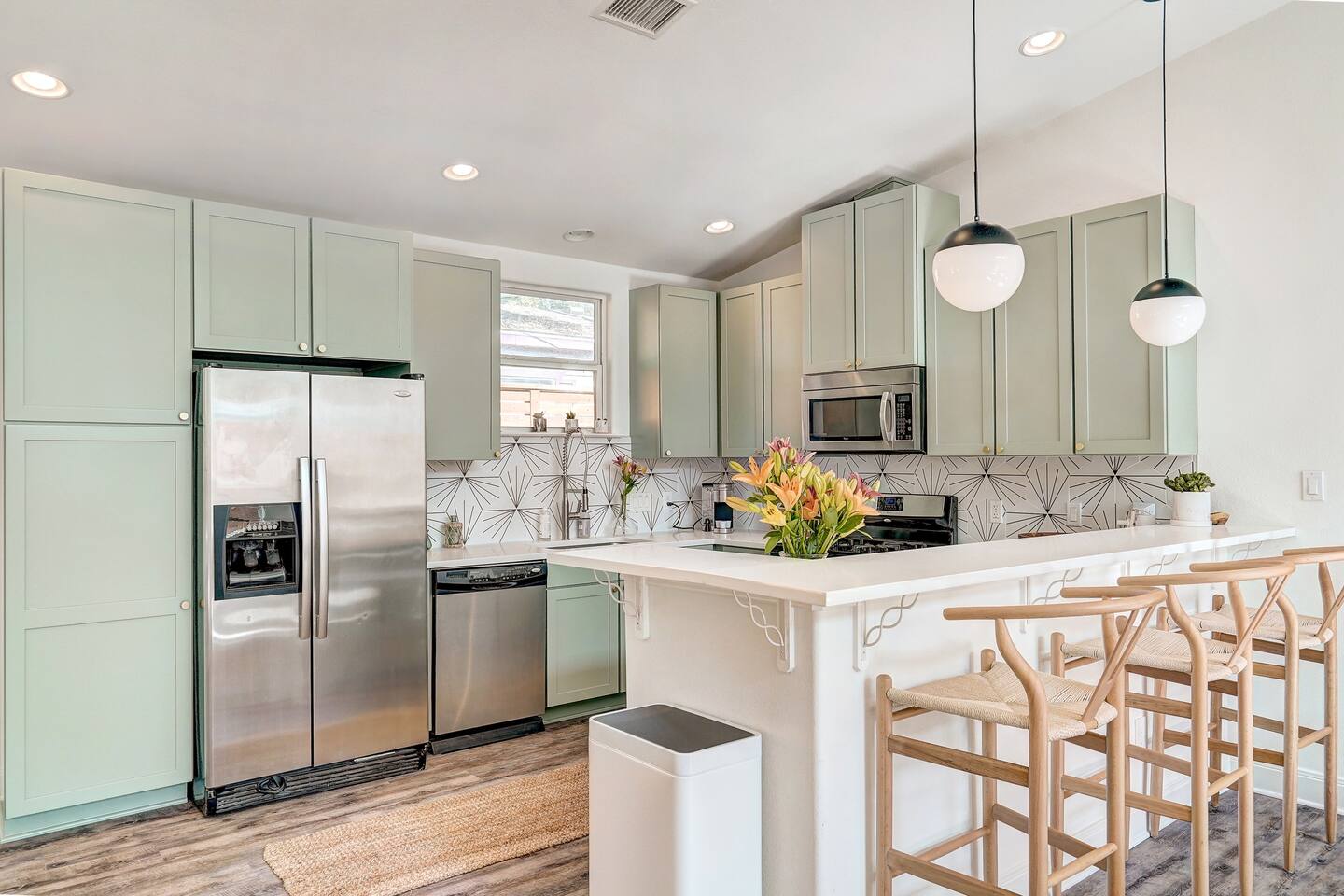 Fully equipped and well-stocked updated kitchen with high chairs.