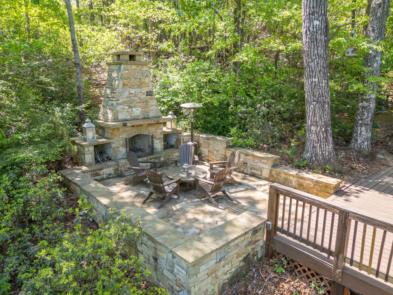 Stone fireplace connected to main-level deck