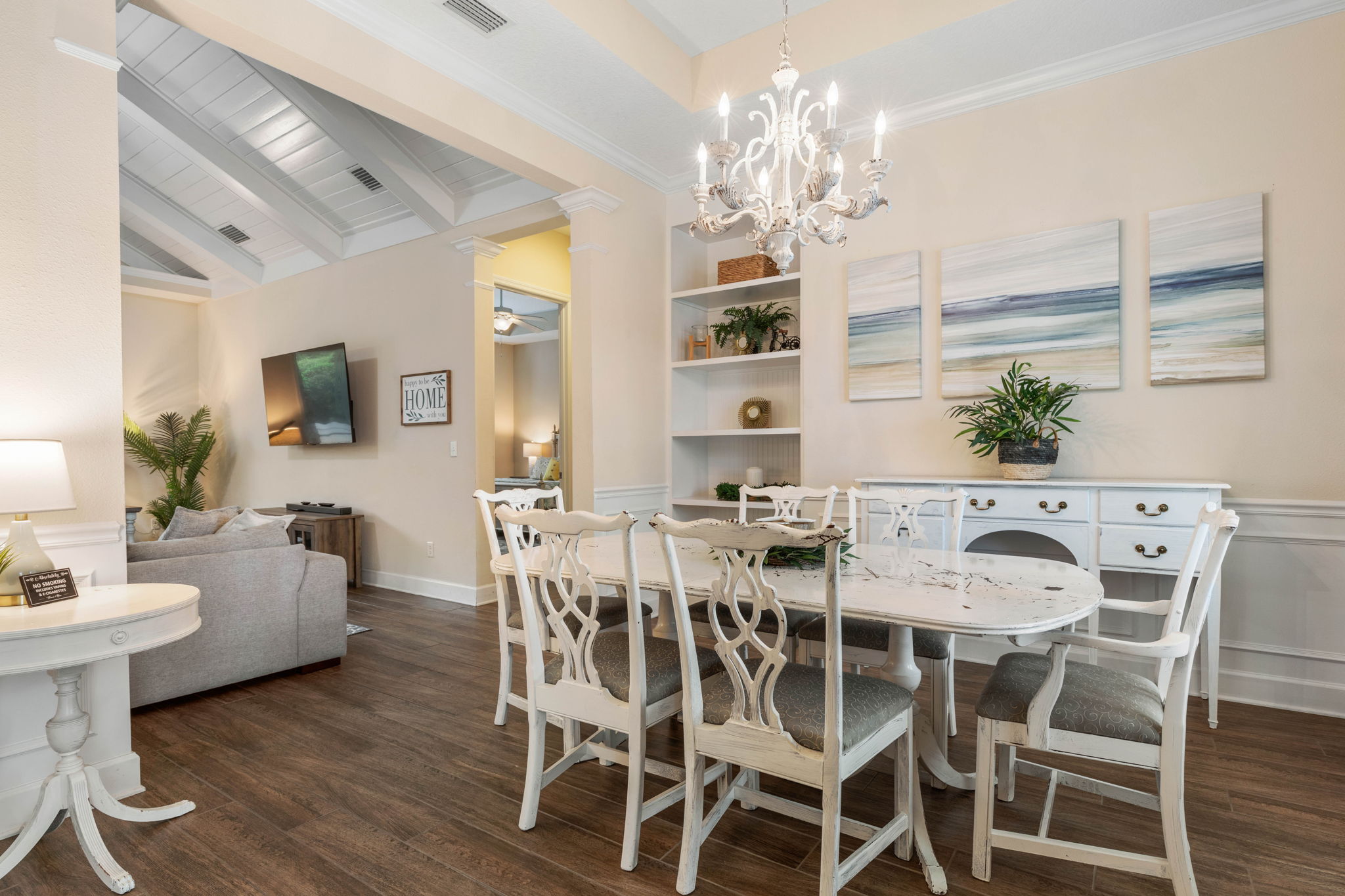 Gather for breakfast beneath the chandelier, linger over dinner after a day at the beach, and let conversation spill into the living room—this airy dining space turns simple meals, shared laughter, and vacation memories into the best part of the day.
